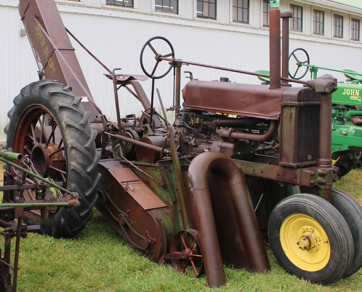 Unrestored unstyled John Deere A with a cotton picker