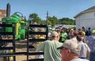 Crowd gathered near a John Deere tractor
