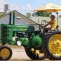 John Deere tractor with a yellow umbrella