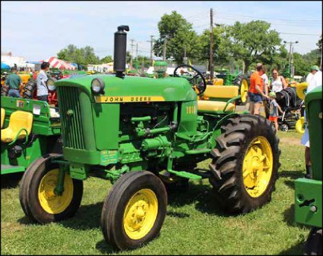 John Deere 1010 tractor at a show with spectators behind