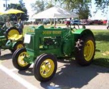John Deere tractor with a yellow umbrella