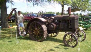 Rusty antique tractor with a sickle mower