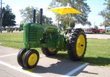 John Deere Model G tractor with a yellow umbrella
