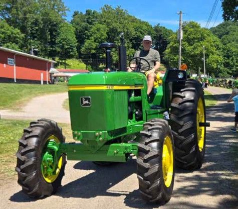 Man driving a John Deere 4430 tractor